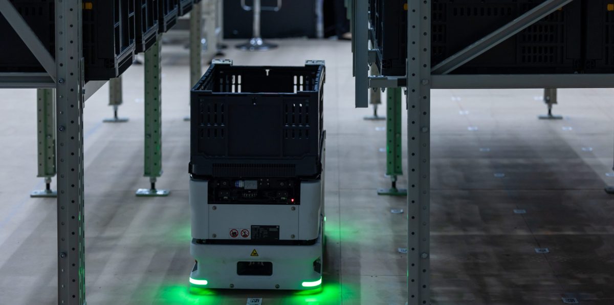 Autonomous mobile case handling robot scissor lift mechanism pick and retrieve plastic tote box from high shelves, Modern automated logistics warehouse smart technology, Robot handling plastic crates